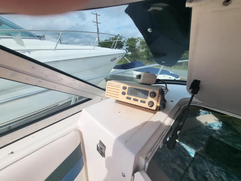 Slide: The Image of 1998 Seaswirl 2300 Walkaround boat interior with radio equipment and window view. - 17
