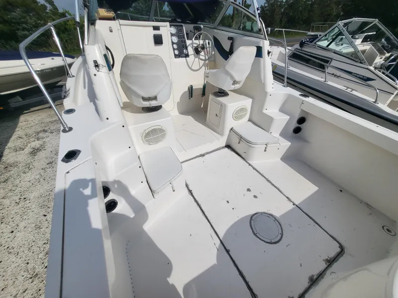 Slide: The Image of 1998 Seaswirl 2300 Walkaround boat interior with seating and control panel. - 18