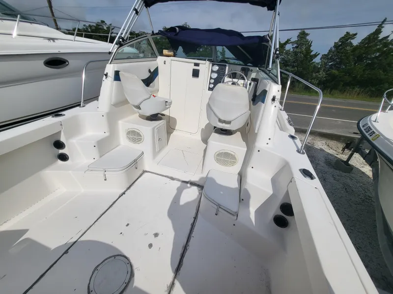 Slide: The Image of 1998 Seaswirl 2300 Walkaround boat interior with seating and steering console. - 3