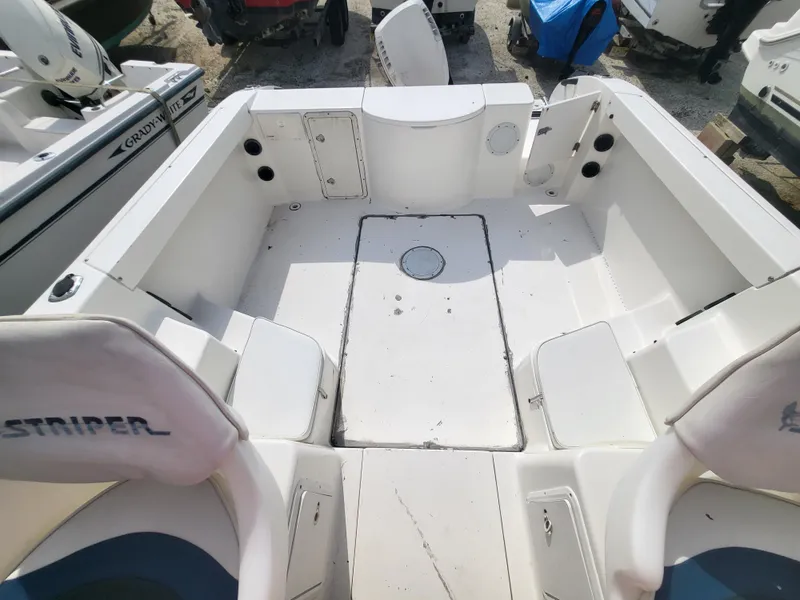 Slide: The Image of 1998 Seaswirl 2300 Walkaround boat interior, featuring spacious seating and storage compartments. - 4