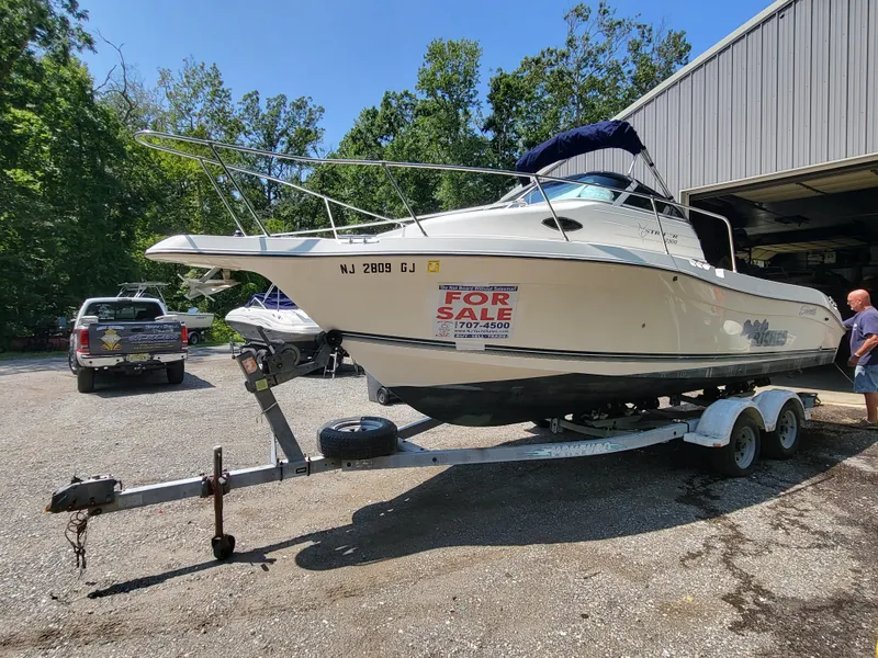 Slide: The Image of 1998 Seaswirl 2300 Walkaround boat on trailer, for sale sign visible. - 8