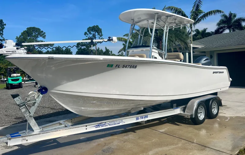 Slide: The Image of 2015 Sportsman 232 boat on a trailer in a driveway. - 1
