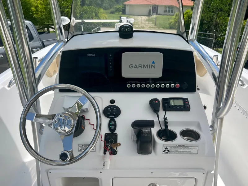 Slide: The Image of 2015 Sportsman 232 boat dashboard with Garmin navigation system and steering wheel. - 13