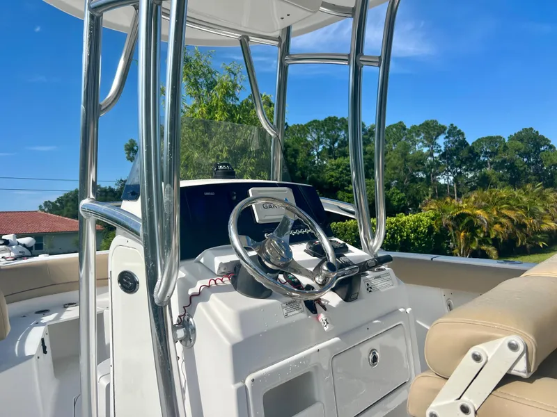 Slide: The Image of 2015 Sportsman 232 boat console with steering wheel and controls. - 14