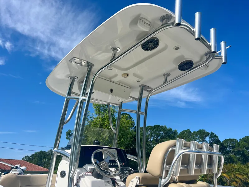 Slide: The Image of 2015 Sportsman 232 boat with T-top and rod holders. - 17