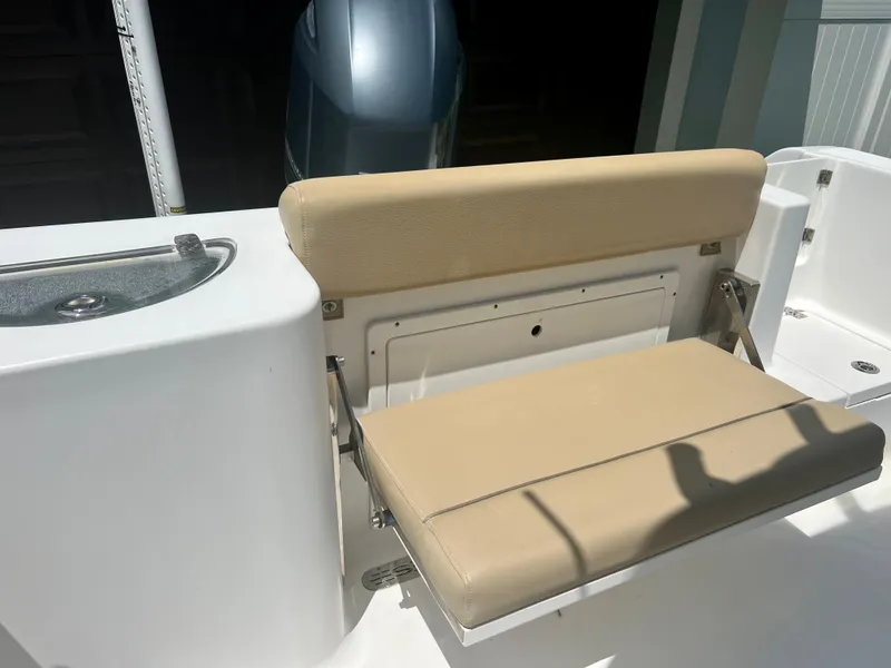 Slide: The Image of 2015 Sportsman 232 boat with beige cushioned seating and engine in background. - 21
