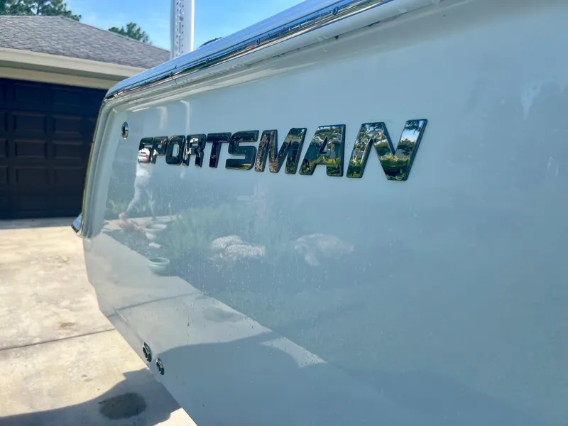 Slide: The Image of 2015 Sportsman 232 boat rear view with logo in driveway. - 23