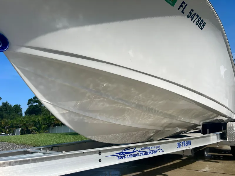 Slide: The Image of 2015 Sportsman 232 boat on Rock and Roll trailer, side view. - 3