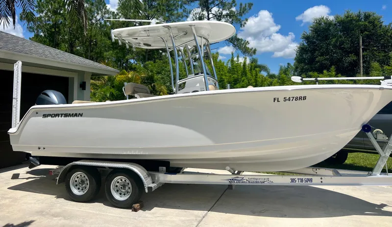 Slide: The Image of 2015 Sportsman 232 boat on trailer in driveway, side view. - 4