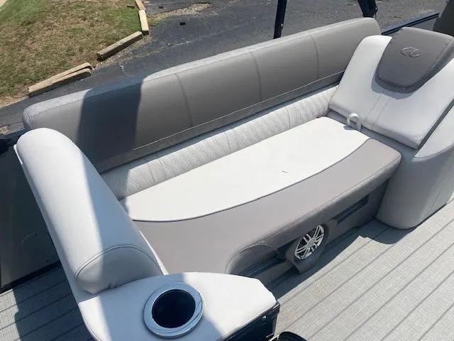 Slide: The Image of 2023 Avalon Catalina 2385 Quad Lounger interior seating with cup holder and speaker. - 16