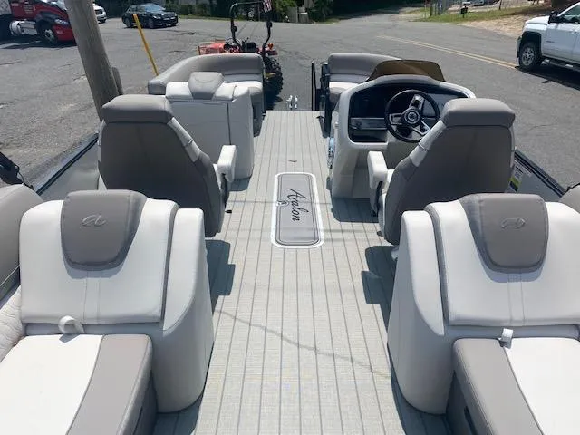 Slide: The Image of 2023 Avalon Catalina 2385 Quad Lounger interior, luxury pontoon boat seating and helm. - 17