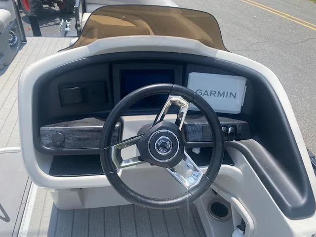 Slide: The Image of 2023 Avalon Catalina 2385 Quad Lounger boat dashboard with Garmin navigation system. - 18