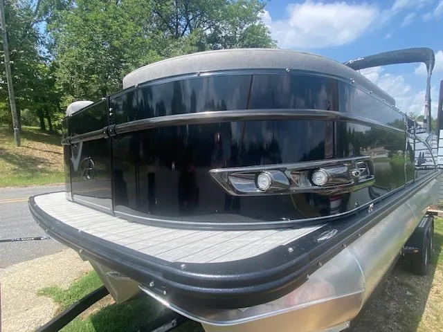 Slide: The Image of 2023 Avalon Catalina 2385 Quad Lounger pontoon boat, black exterior, docked on a sunny day. - 3