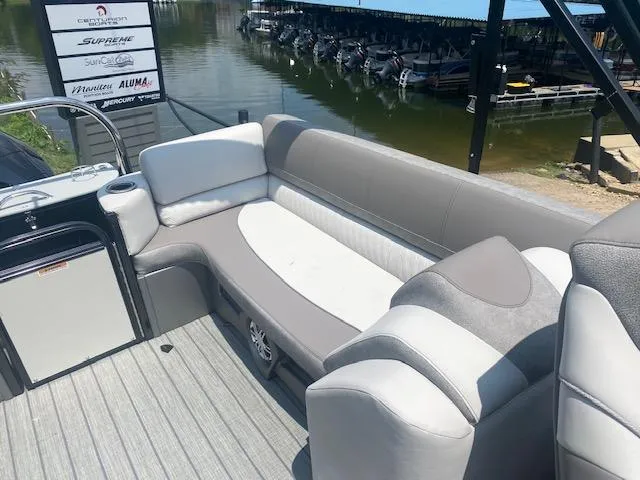 Slide: The Image of 2023 Avalon Catalina 2385 Quad Lounger boat interior with gray and white seating. - 8