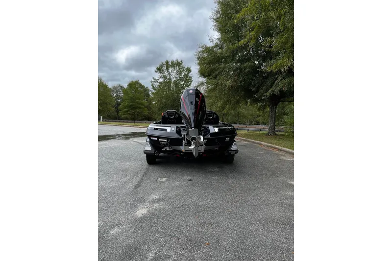 Slide: The Image of 2024 Ranger Z520R Ranger Cup Equipped boat on a paved road, surrounded by trees. - 4