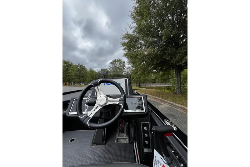 Slide: The Image of 2024 Ranger Z520R Ranger Cup boat dashboard with steering wheel and control panel. - 6