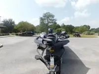 Slide: The Image of 2024 Ranger RT178C fishing boat in a parking lot. - 3