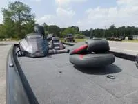 Slide: The Image of 2024 Ranger RT178C fishing boat with seating and motor, parked outdoors. - 5