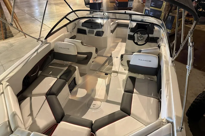 Slide: The Image of 2024 Tahoe 210 S boat interior with sleek seating and modern dashboard design. - 4