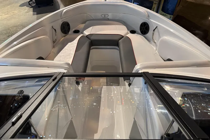 Slide: The Image of 2024 Tahoe 210 S boat interior with cushioned seating and speakers. - 5