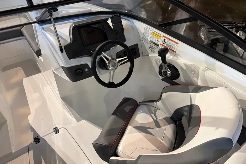 Slide: The Image of Interior of 2024 Tahoe 210 S boat featuring steering wheel and control panel. - 6