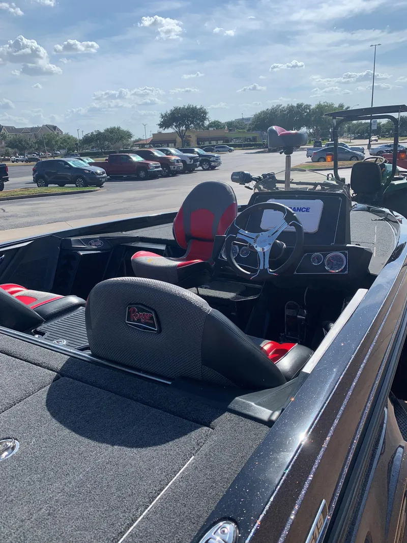 Slide: The Image of 2024 Ranger Z519 Ranger Cup Equipped boat interior in a parking lot. - 4