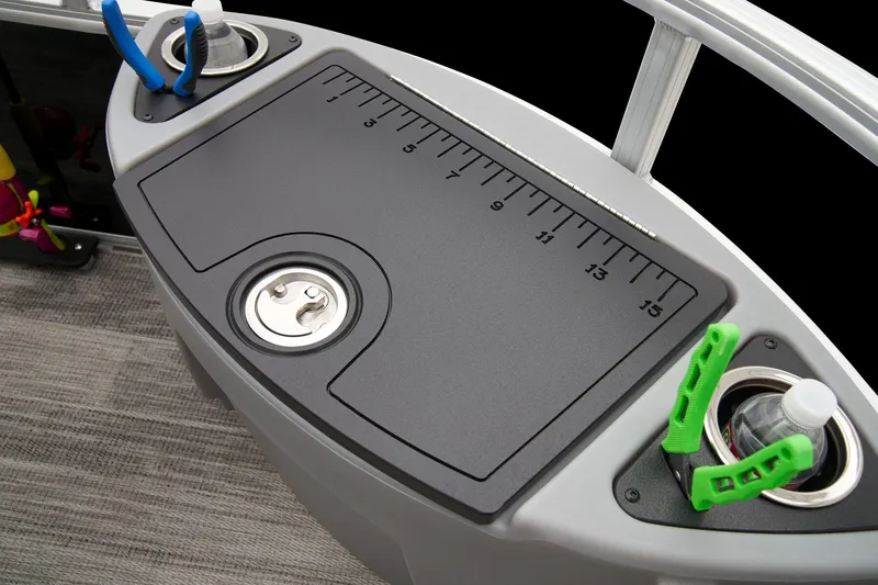 Slide: The Image of 2024 Ranger Reata 223F fishing station with measuring board and rod holders. - 26