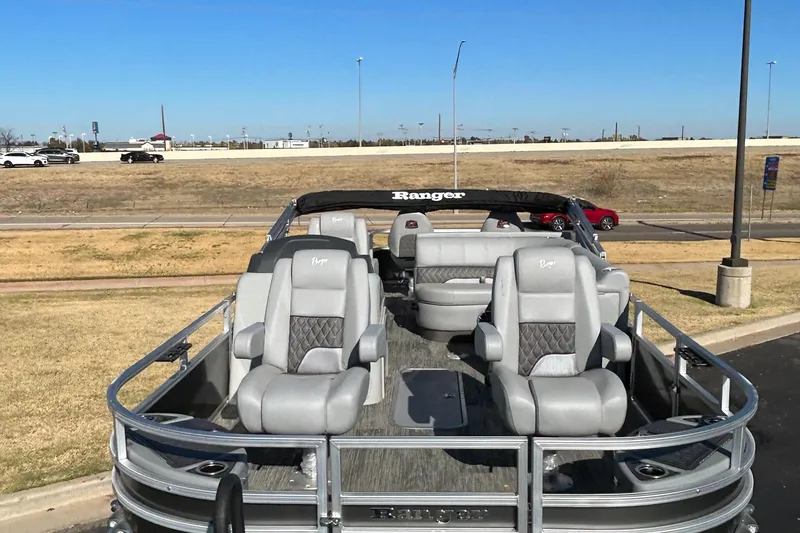 Slide: The Image of 2024 Ranger Reata 223F pontoon boat with gray seating and open deck. - 3