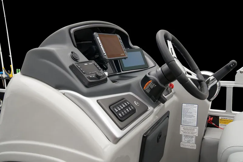 Slide: The Image of 2024 Ranger Reata 223F boat dashboard with steering wheel and electronic controls. - 32