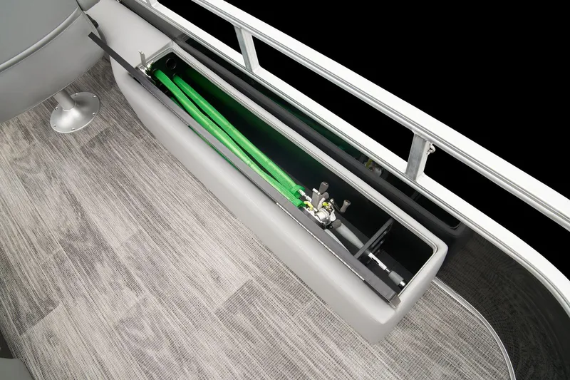 Slide: The Image of 2024 Ranger Reata 223F boat storage compartment with fishing rods. - 44