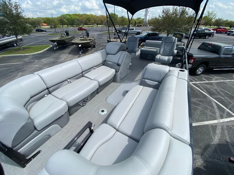 Slide: The Image of 2024 Regency 250 DL3 pontoon boat with spacious seating and modern design. - 2