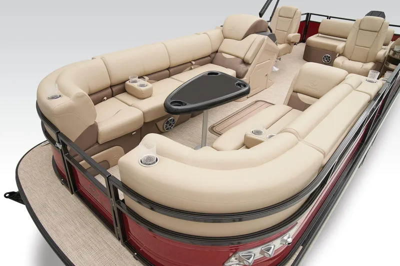 Slide: The Image of 2024 Regency 250 DL3 pontoon boat with luxurious beige seating and a black table. - 22