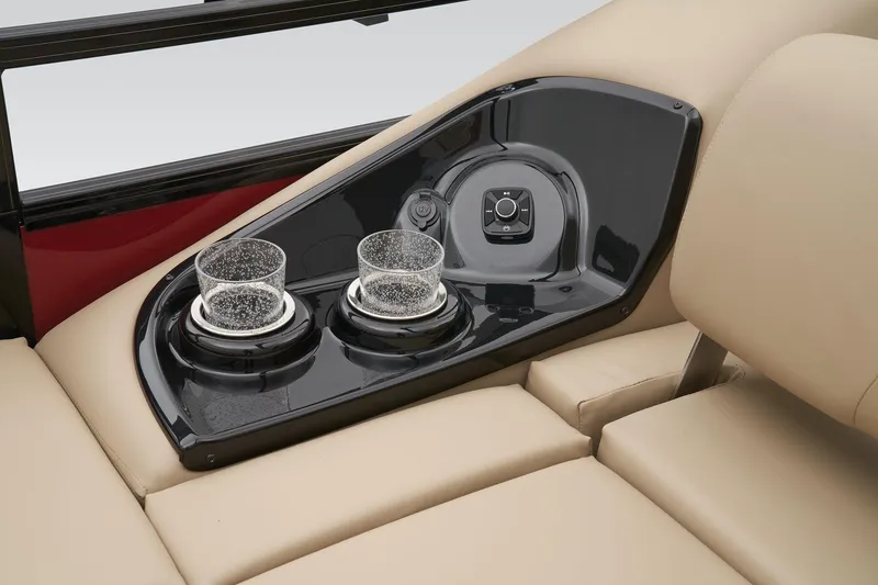 Slide: The Image of 2024 Regency 250 DL3 boat cup holders and control panel on beige seating. - 38