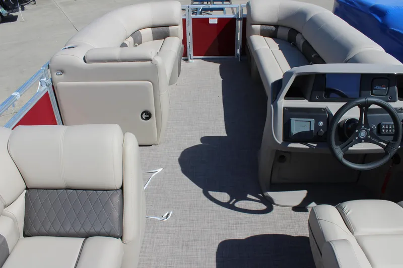 Slide: The Image of 2024 Sun Tracker Party Barge 20 DLX interior with plush seating and modern dashboard. - 3