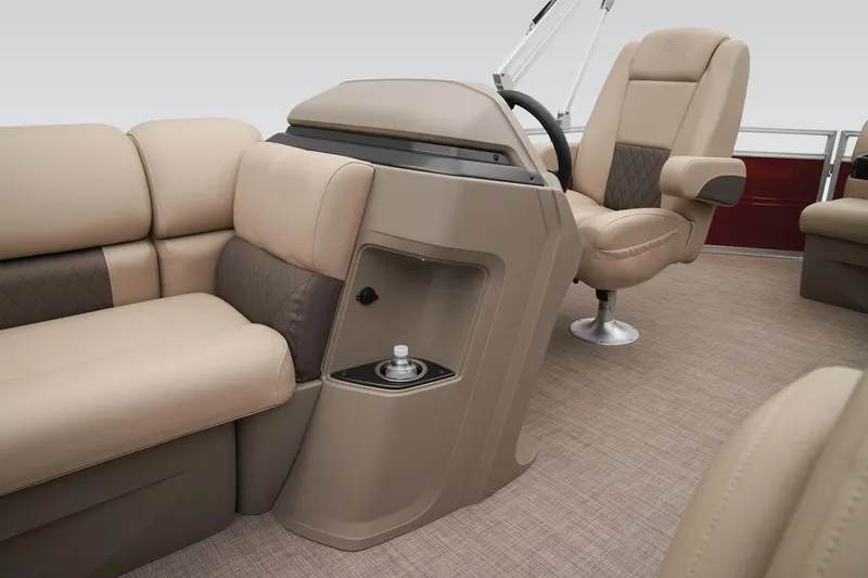 Slide: The Image of 2024 Sun Tracker Party Barge 20 DLX interior with beige seating and steering console. - 32