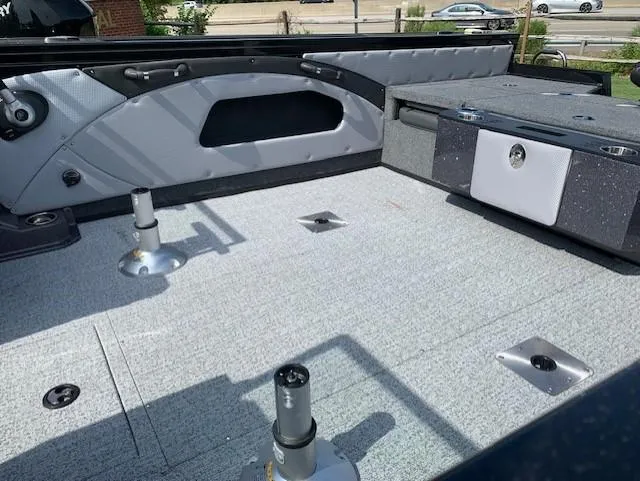 Slide: The Image of 2024 Ranger VX1888 WT boat interior with gray flooring and seating mounts. - 11