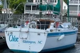 Slide: The Image of 1986 Laguna 30 sailboat docked, Wilmington, NC, with green canopy and white hull. - 20