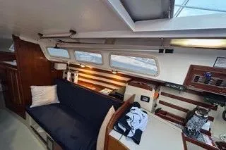 Slide: The Image of Interior of 1986 Laguna 30 sailboat with cozy seating and wooden accents. - 22