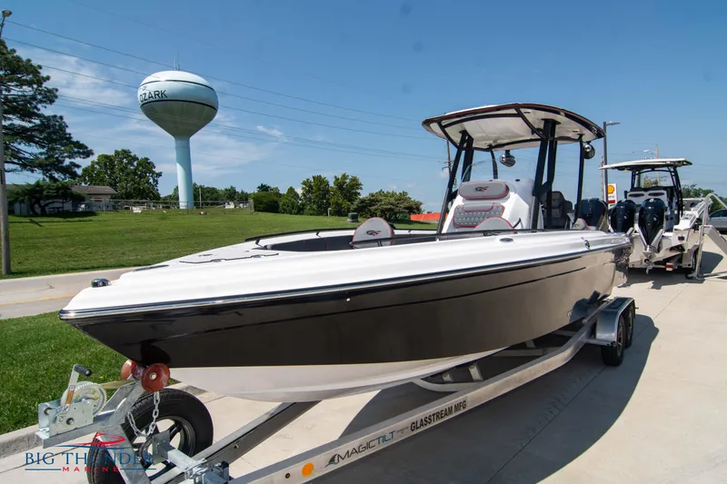 Slide: The Image of 2024 Glasstream 28 GSX Pro boat on a trailer in a marina. - 3