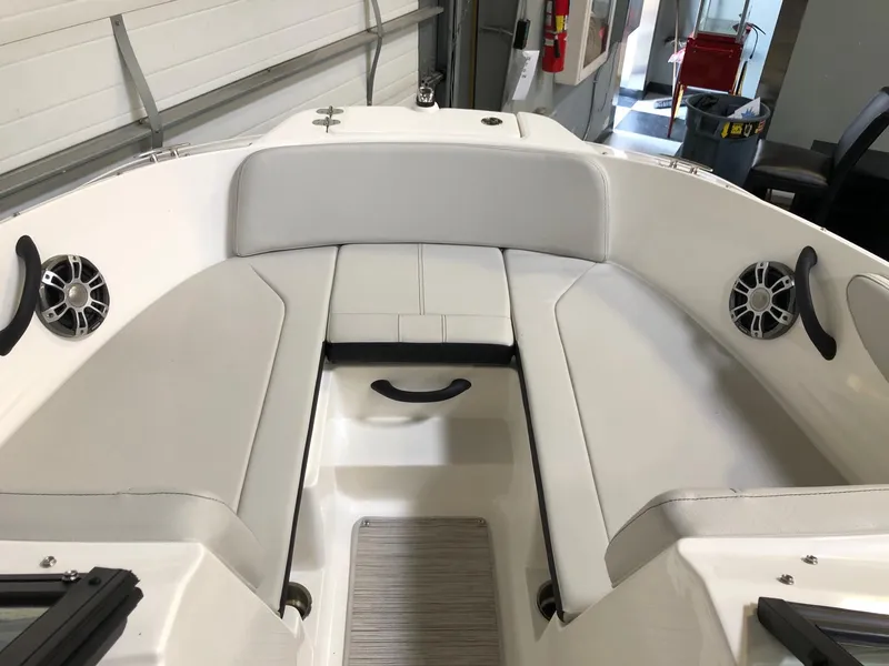 Slide: The Image of 2023 Sea Ray SPX 210 boat interior with white seating and speakers. - 10