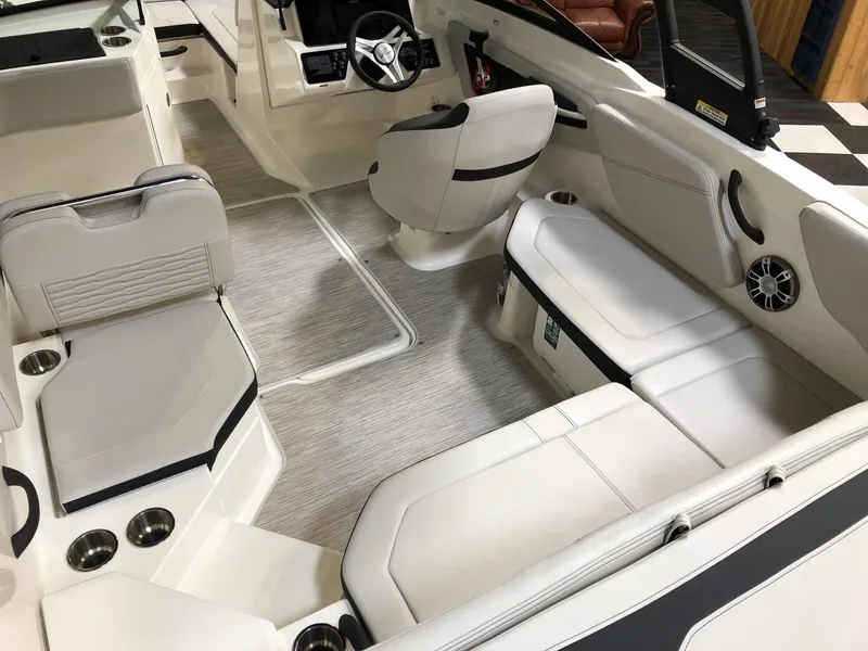 Slide: The Image of 2023 Sea Ray SPX 210 boat interior with white seating and modern design. - 4