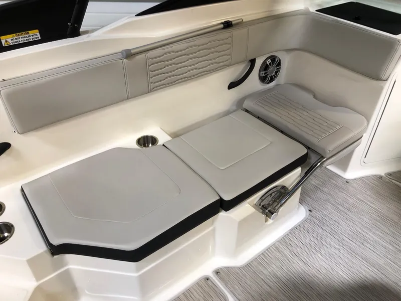 Slide: The Image of 2023 Sea Ray SPX 210 boat interior seating with cup holders and speaker. - 7