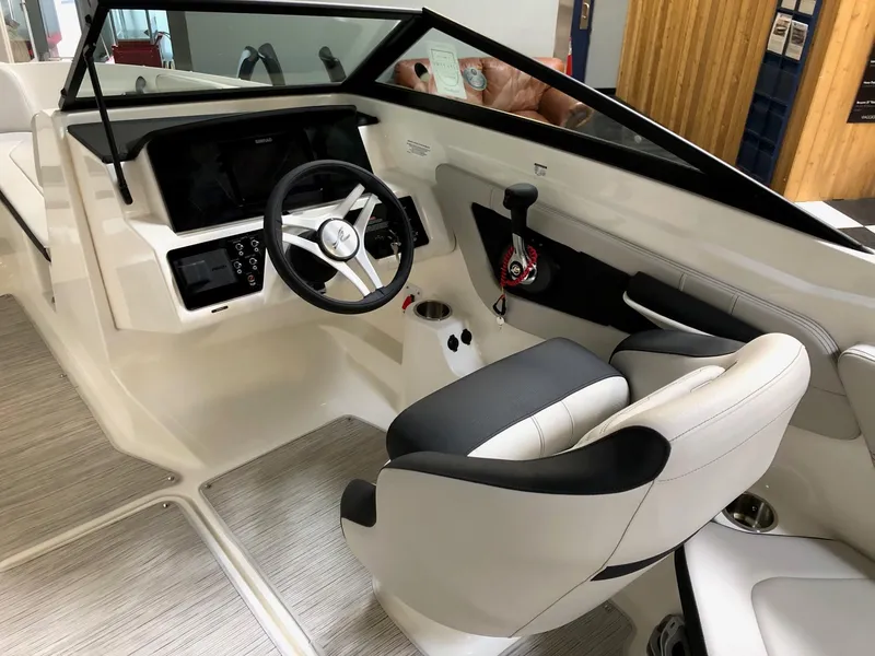 Slide: The Image of 2023 Sea Ray SPX 210 boat interior with steering wheel and captain's seat. - 8