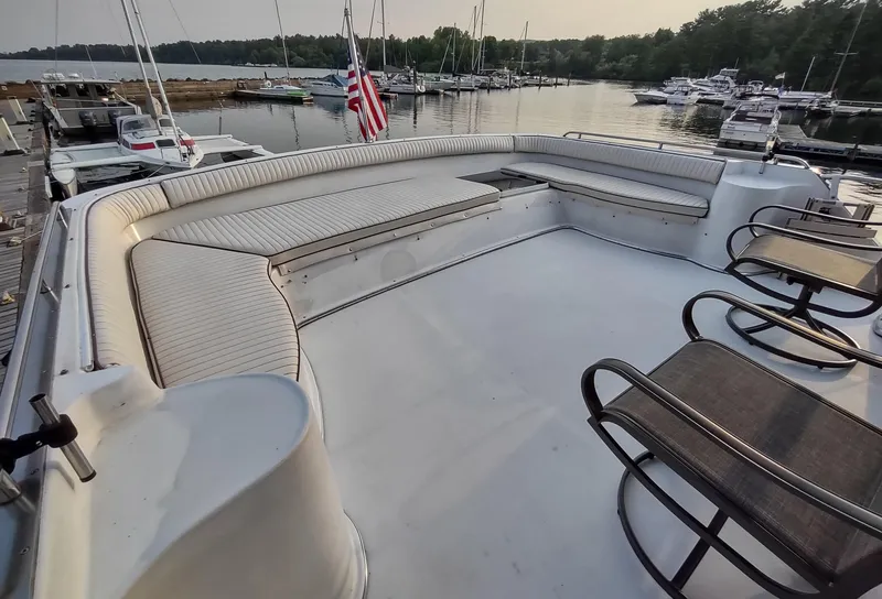 Slide: The Image of 1991 Bluewater Coastal Cruiser yacht deck with seating, docked at a marina. - 12