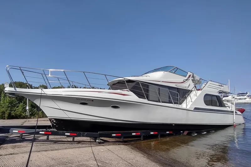 Slide: The Image of 1991 Bluewater Coastal Cruiser yacht on trailer by water, clear sky background. - 19