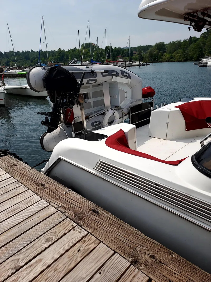 Slide: The Image of 1991 Bluewater Coastal Cruiser docked at a marina with other boats in the background. - 3