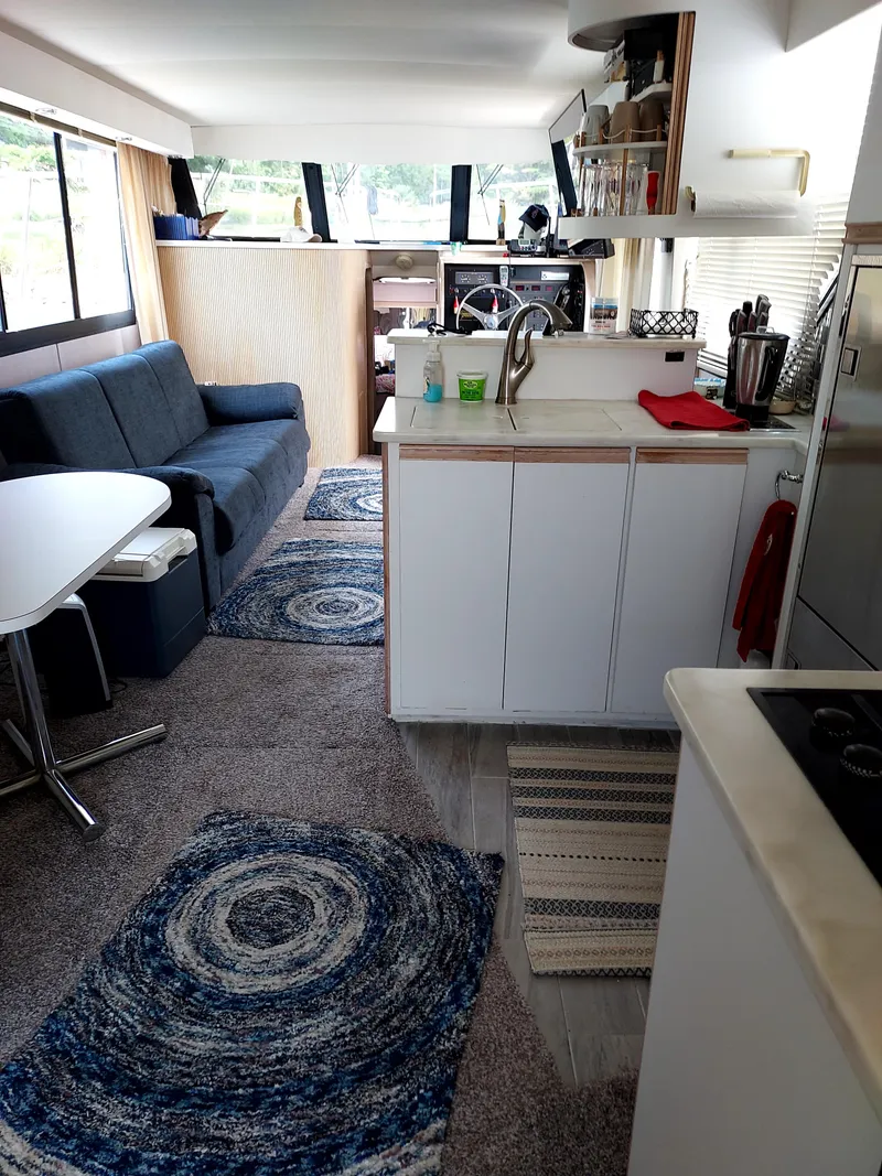 Slide: The Image of Interior of a 1991 Bluewater Coastal Cruiser with modern kitchen and cozy seating area. - 4