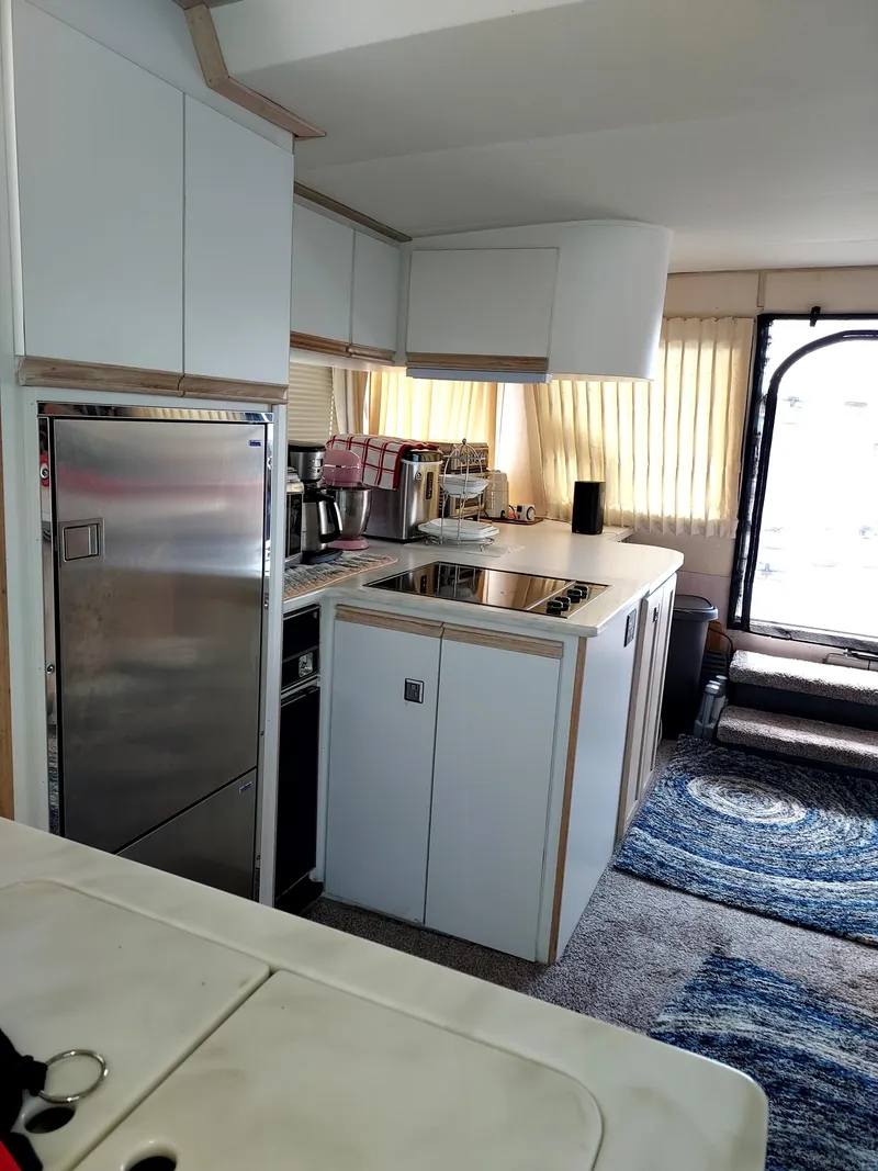 Slide: The Image of 1991 Bluewater Coastal Cruiser kitchen interior with modern appliances and cozy design. - 5