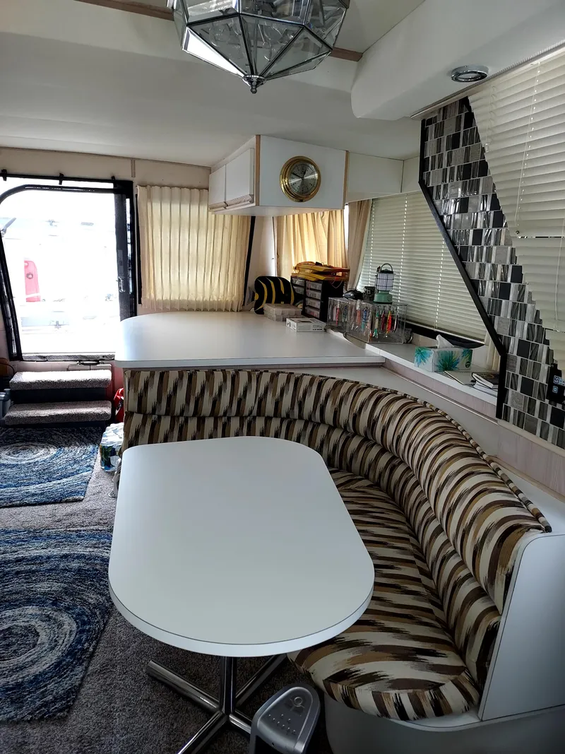 Slide: The Image of Interior of a 1991 Bluewater Coastal Cruiser with modern seating and stylish decor. - 7
