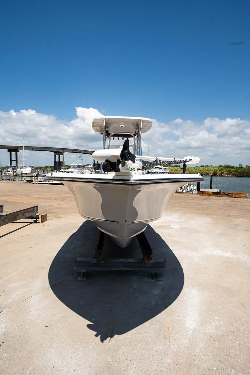 Slide: The Image of 2021 Key West 244 Center Console boat on a dock with a bridge in the background. - 10